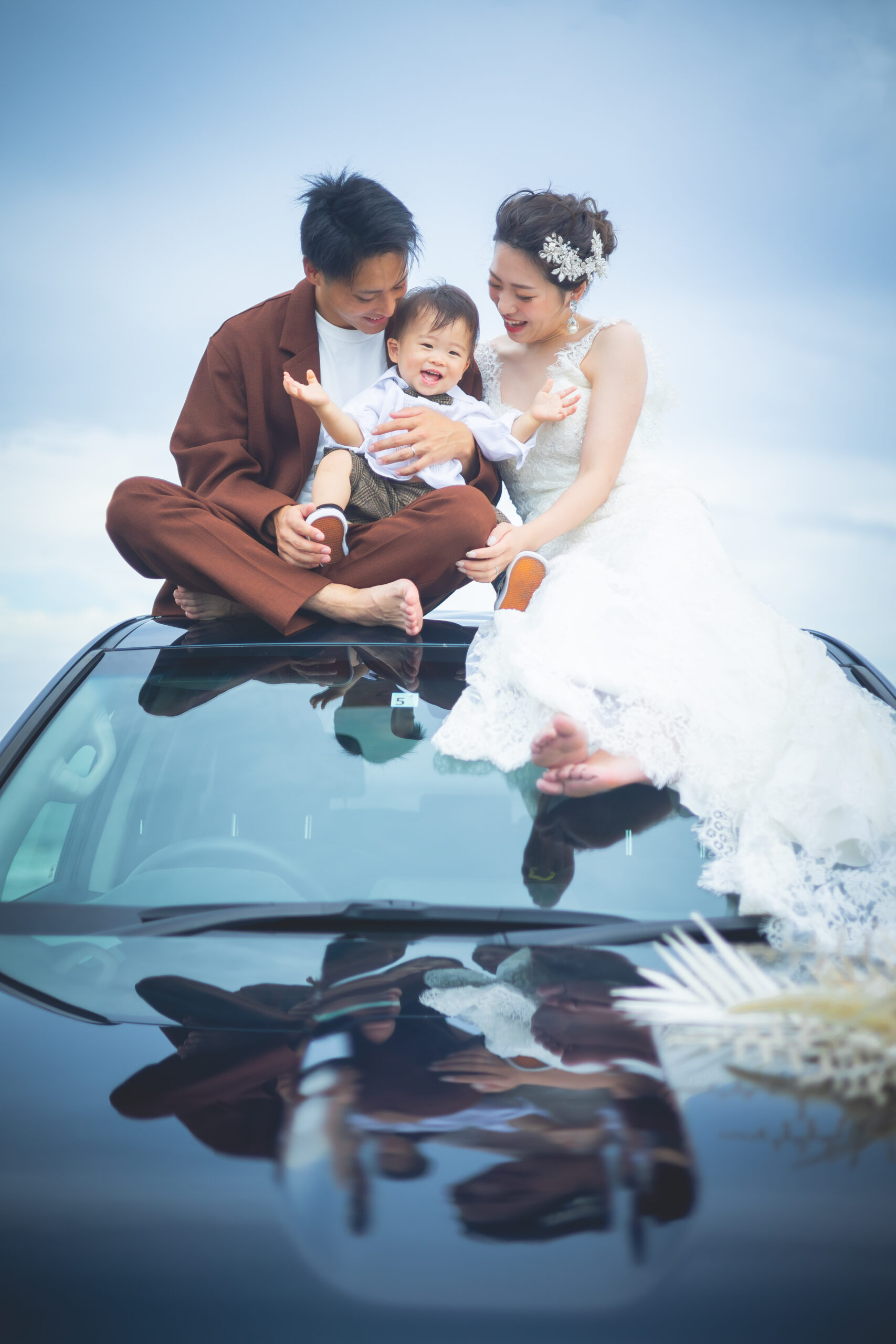 子連れフォトウェディングで愛車に乗ってポーズを撮る3人家族
